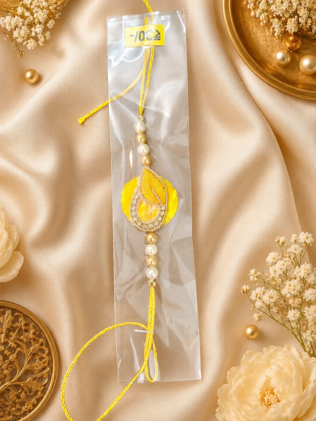 9. Handcrafted Designer Pearl Rakhi with Kundan Leaf Charm